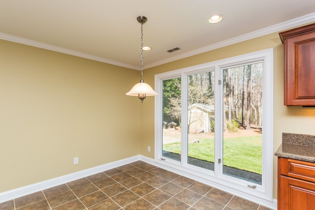3120 Mt Vernon Church Road Raleigh, NC 27613 - Photo 2 of 9 The breakfast room and kitchen are open to the family room which offers a gas FIREPLACE. Beautiful windows provide NATURAL LIGHT and a view of the 1 ACRE WOODED LOT. Breakfast room