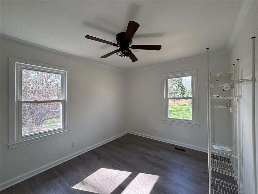 3854 Davis Street Suwanee, GA 30024 - Photo 13 of 24 wooden floor in an empty room with a window