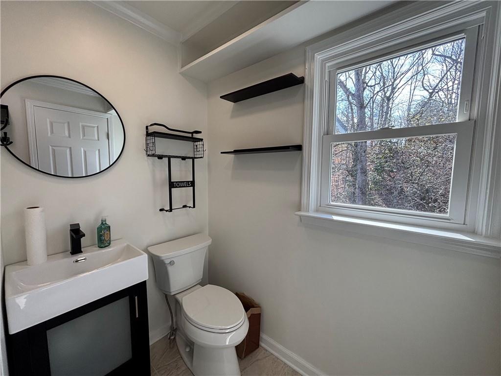 3854 Davis Street Suwanee, GA 30024 - Photo 18 of 24 a bathroom with a toilet a sink and a mirror