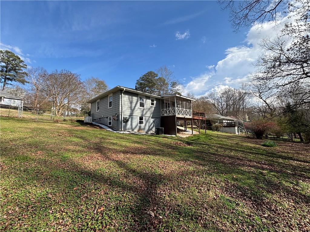 3854 Davis Street Suwanee, GA 30024 - Photo 21 of 24 a view of a big house with a big yard and large trees
