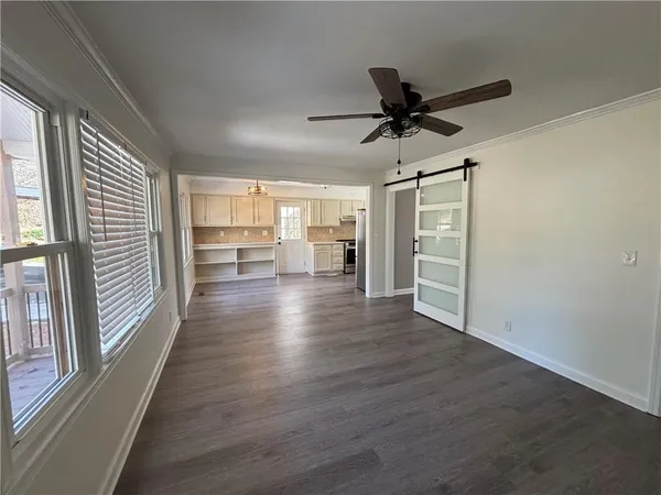 wooden floor in an empty room with a window