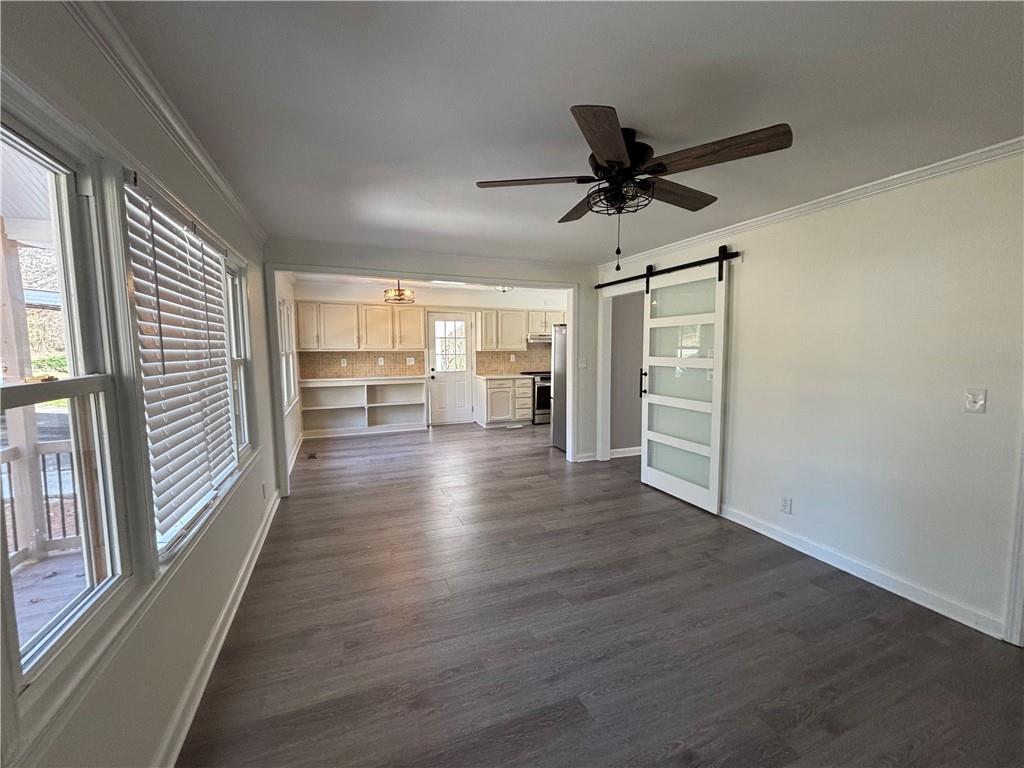 3854 Davis Street Suwanee, GA 30024 - Photo 3 of 24 wooden floor in an empty room with a window