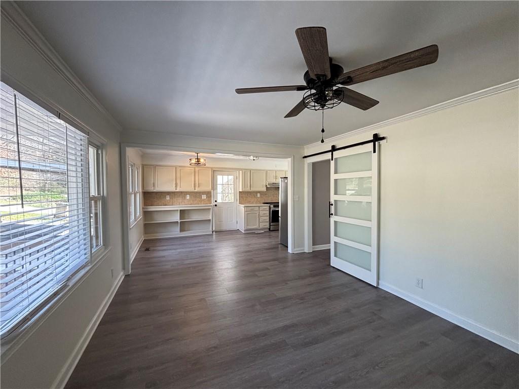 3854 Davis Street Suwanee, GA 30024 - Photo 4 of 24 a view of a room with wooden floor and ceiling fan