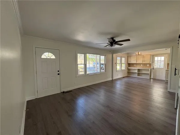 wooden floor in an empty room with a window