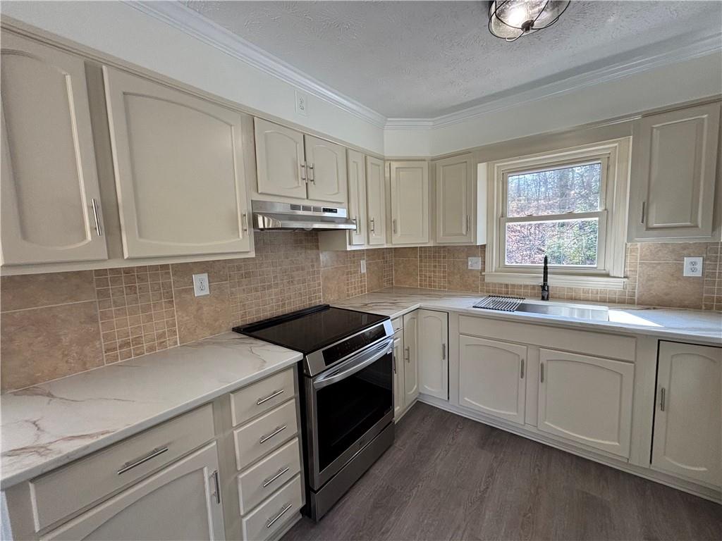 3854 Davis Street Suwanee, GA 30024 - Photo 9 of 24 a kitchen with appliances cabinets and a sink