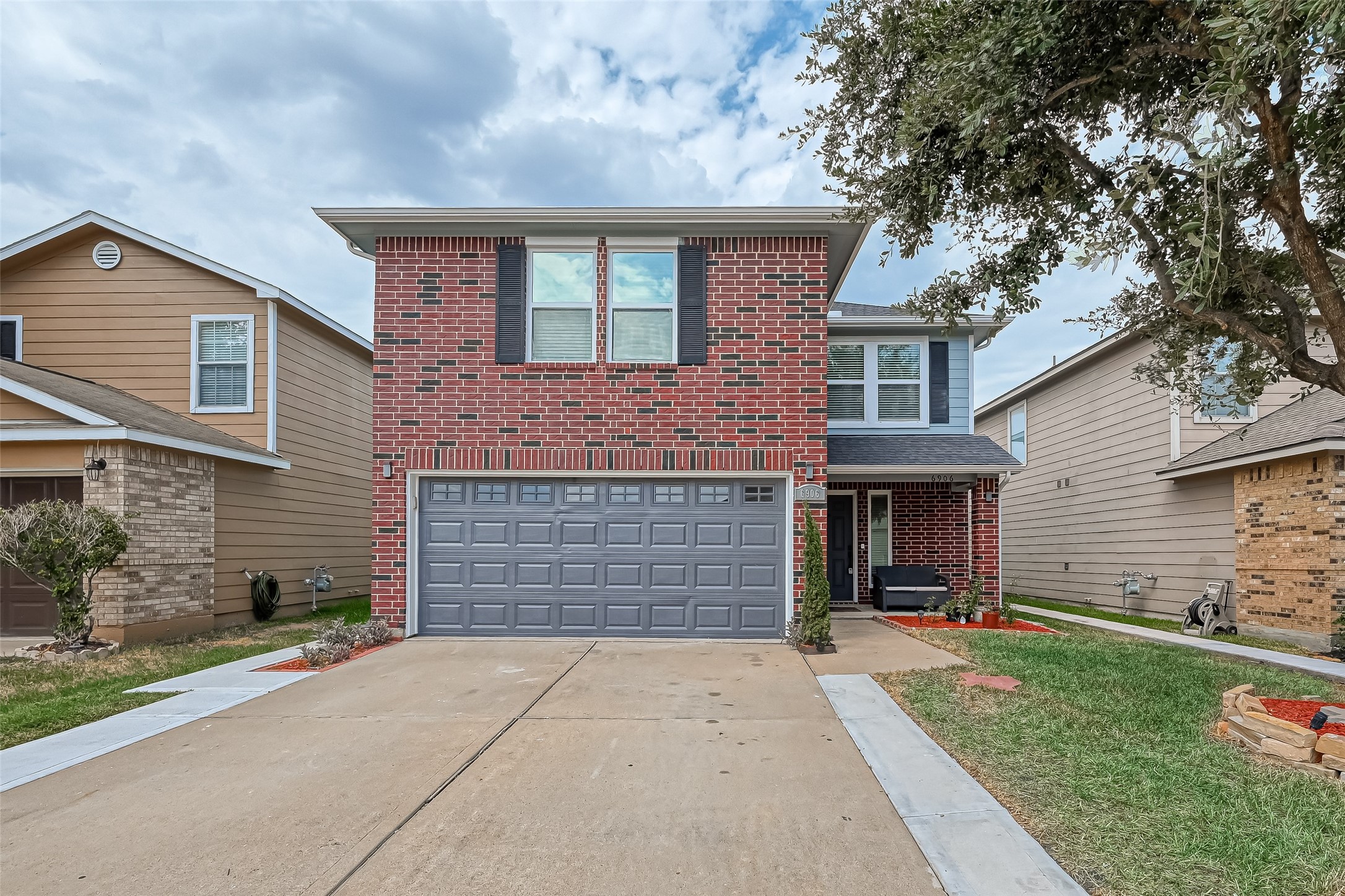 6906 Anson Point Lane Houston, TX 77040 - Photo 1 of 31 a front view of a house with a yard and garage