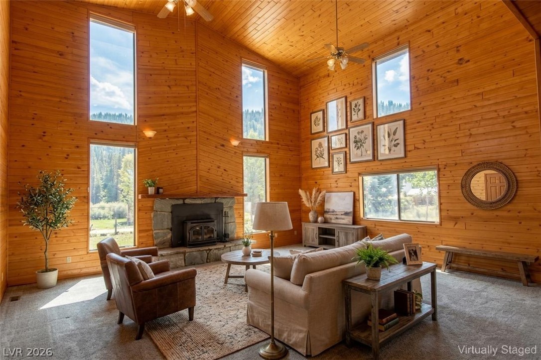 1129 East Ponderosa Road Hatch, UT 84735 - Photo 3 of 47 Soaring wood-plank ceilings and a stone-accented hearth define this warm, light-filled living area.