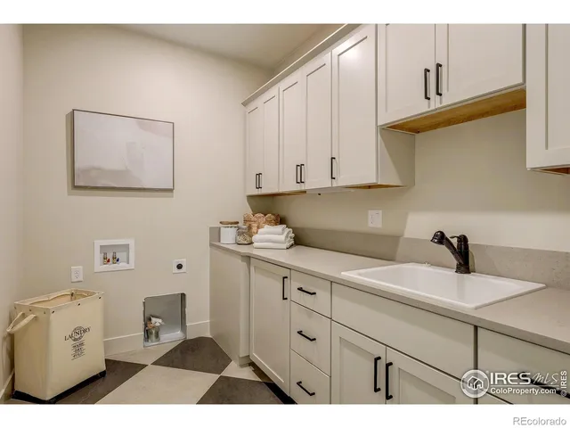 a kitchen with cabinets appliances and a sink