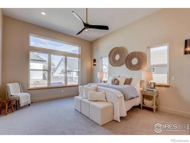 a bedroom with a bed mirror and window