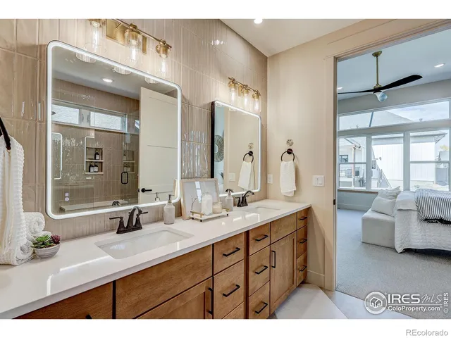 a bathroom with double vanity sinks double vanity tub shower and a mirror