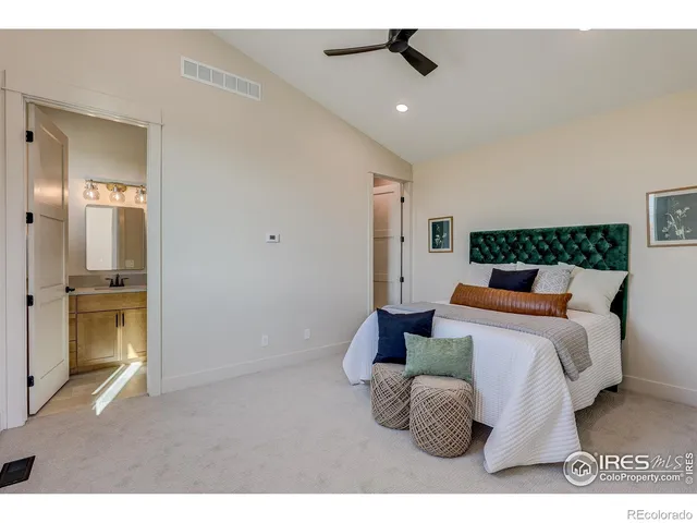 a bedroom with a bed and a couch