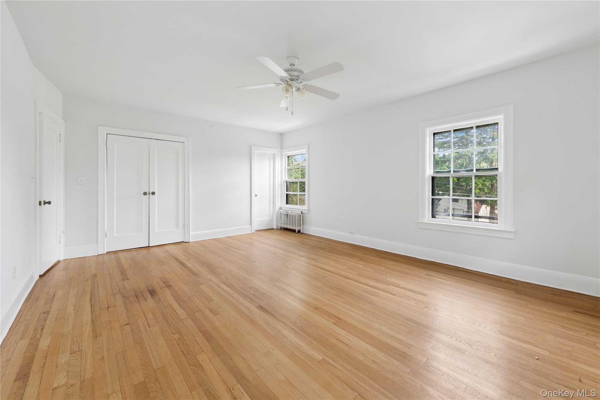 17 Old Orchard Road New Rochelle, NY 10804 - Photo 25 of 32 a view of an empty room with wooden floor and a window