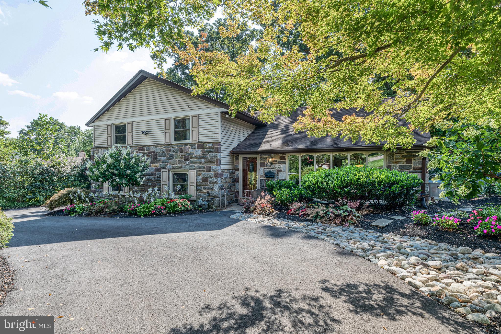 1224 Remington Road Wynnewood, PA 19096 - Photo 1 of 42 a front view of a house with a yard and garage