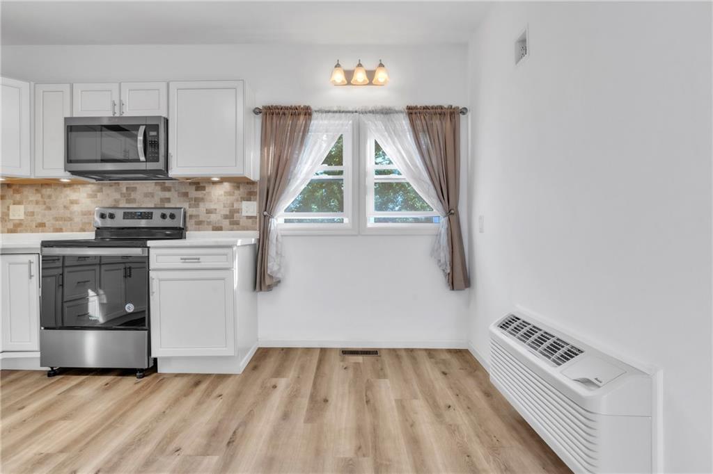 841 Railroad Street McKees Rocks, PA 15136 - Photo 11 of 44 a kitchen with a stove a sink and a microwave