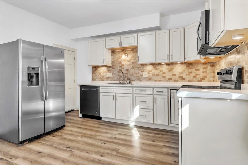 841 Railroad Street McKees Rocks, PA 15136 - Photo 13 of 44 a kitchen with granite countertop a refrigerator and a sink