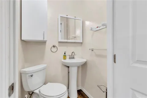 a bathroom with a sink a toilet and mirror