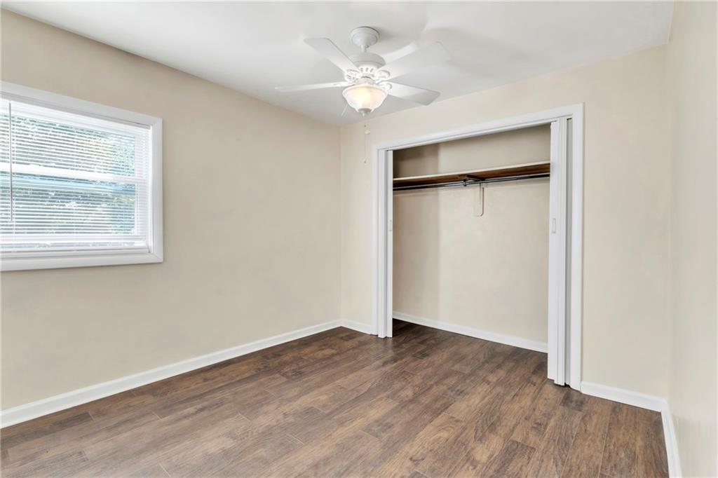 841 Railroad Street McKees Rocks, PA 15136 - Photo 19 of 44 an empty room with a window and a ceiling fan