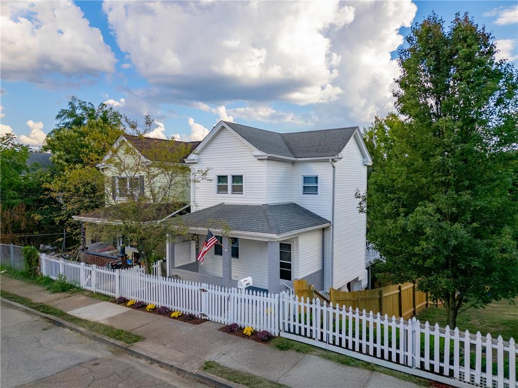 841 Railroad Street McKees Rocks, PA 15136 - Photo 2 of 44 a view of a house with wooden fence next to a road