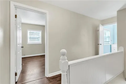 a view of hallway with wooden floor