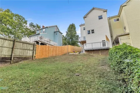 a view of a house with backyard and a tree
