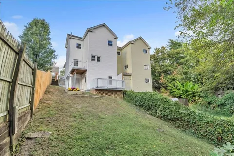 an aerial view of multiple houses with yard