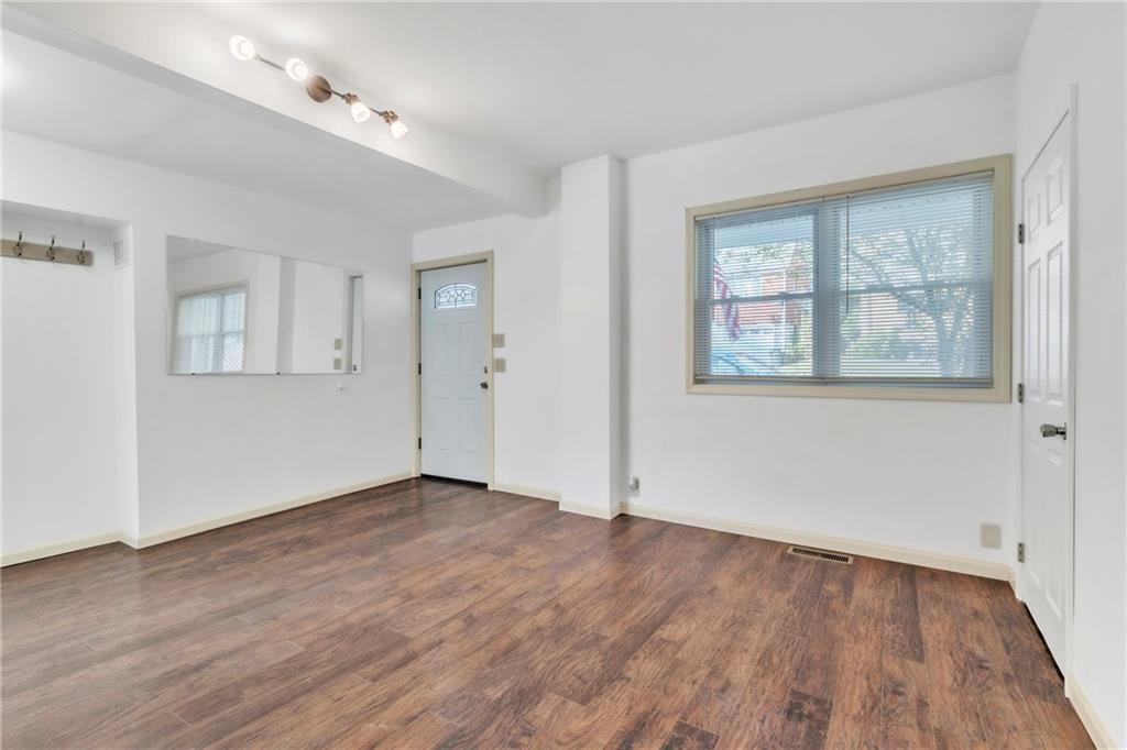 841 Railroad Street McKees Rocks, PA 15136 - Photo 8 of 44 a view of an empty room with wooden floor and a window