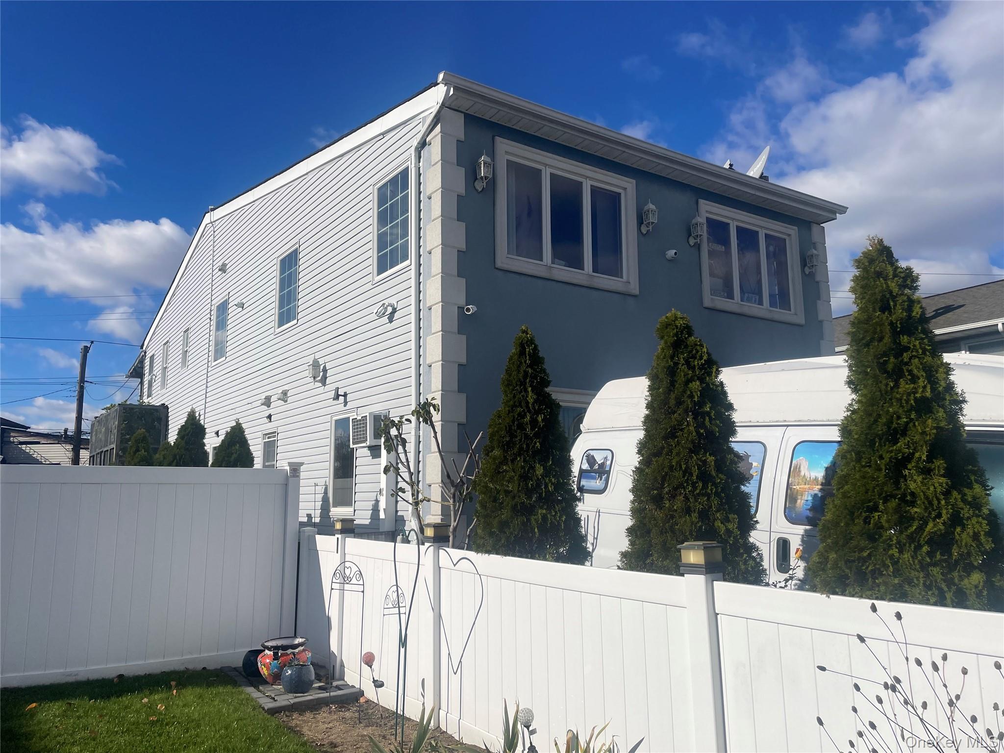 104 Ostend Road Island Park, NY 11558 - Photo 2 of 42 a front view of a house with a yard
