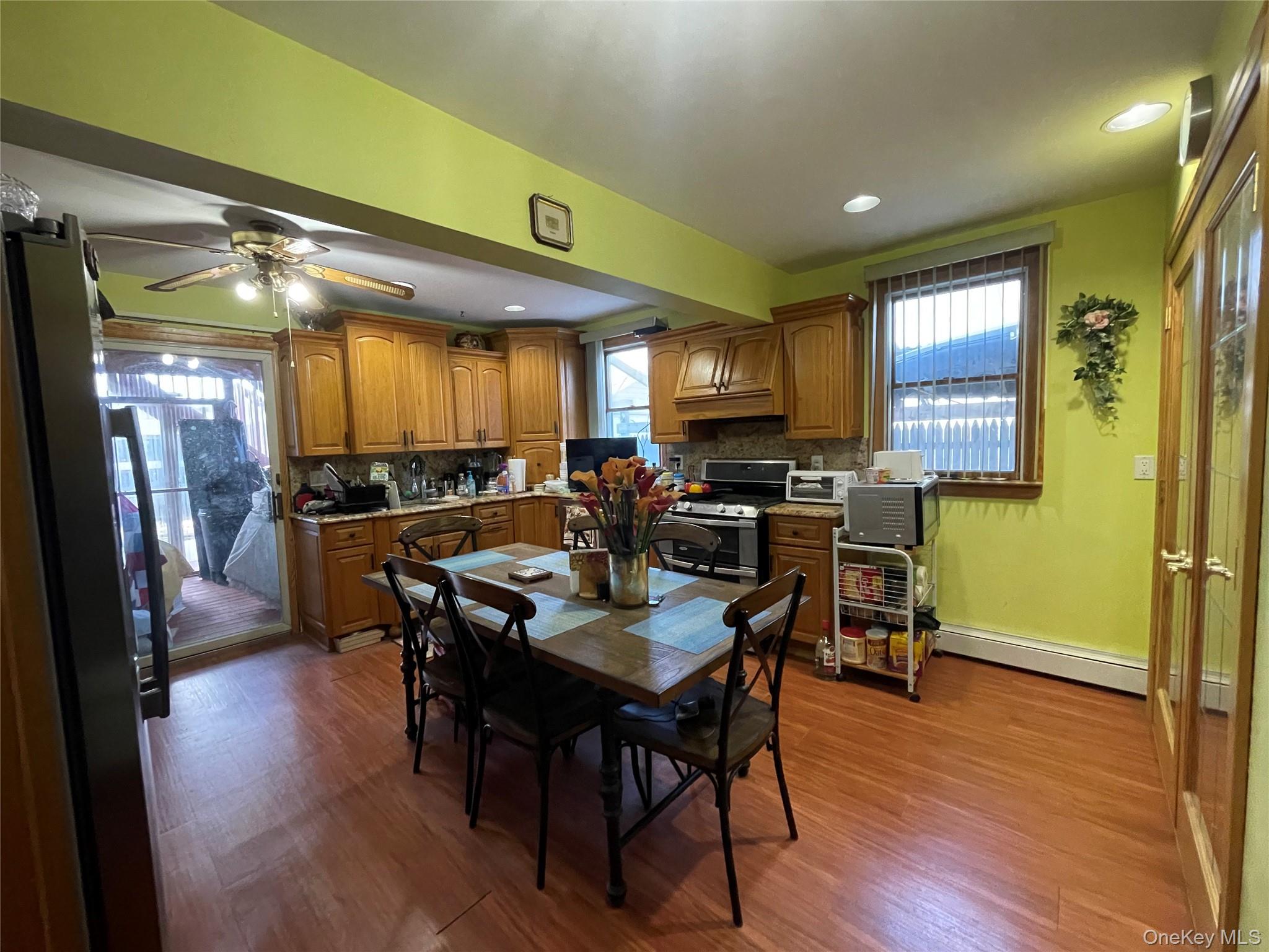 104 Ostend Road Island Park, NY 11558 - Photo 22 of 42 a view of a dining area with furniture window and wooden floor