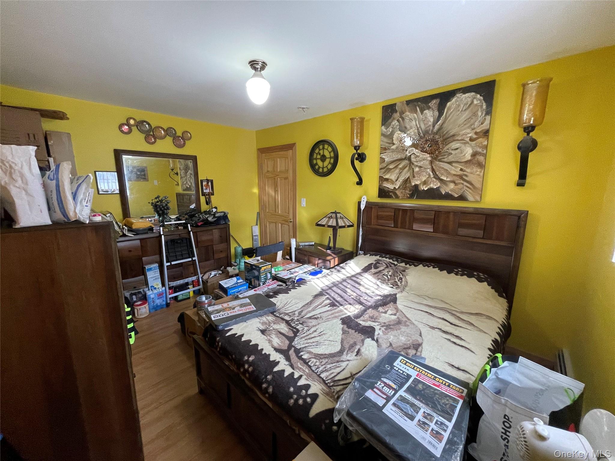 104 Ostend Road Island Park, NY 11558 - Photo 25 of 42 a bedroom with a bed and wooden floor