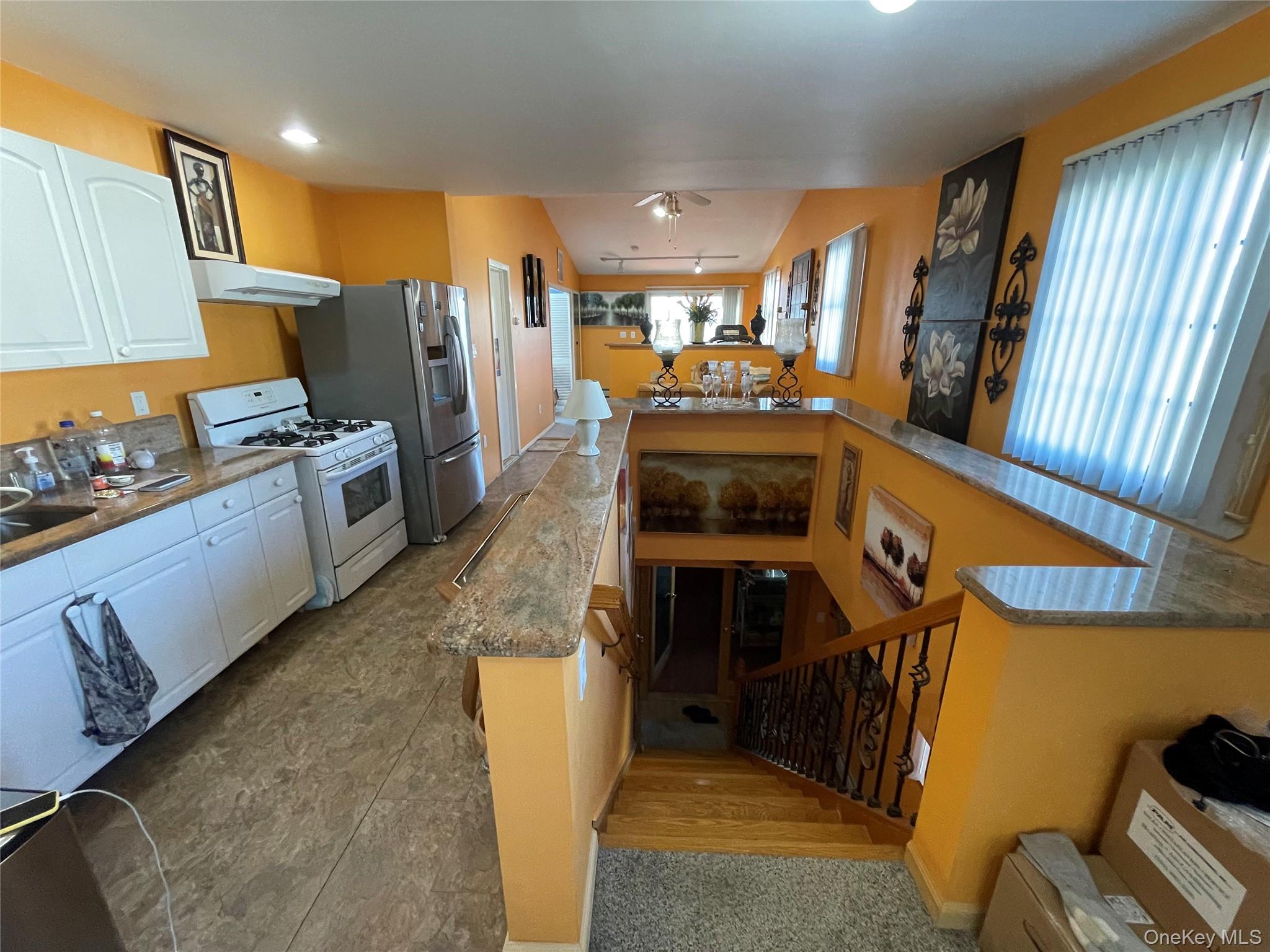 104 Ostend Road Island Park, NY 11558 - Photo 27 of 42 a kitchen with stainless steel appliances granite countertop a refrigerator a stove and a sink