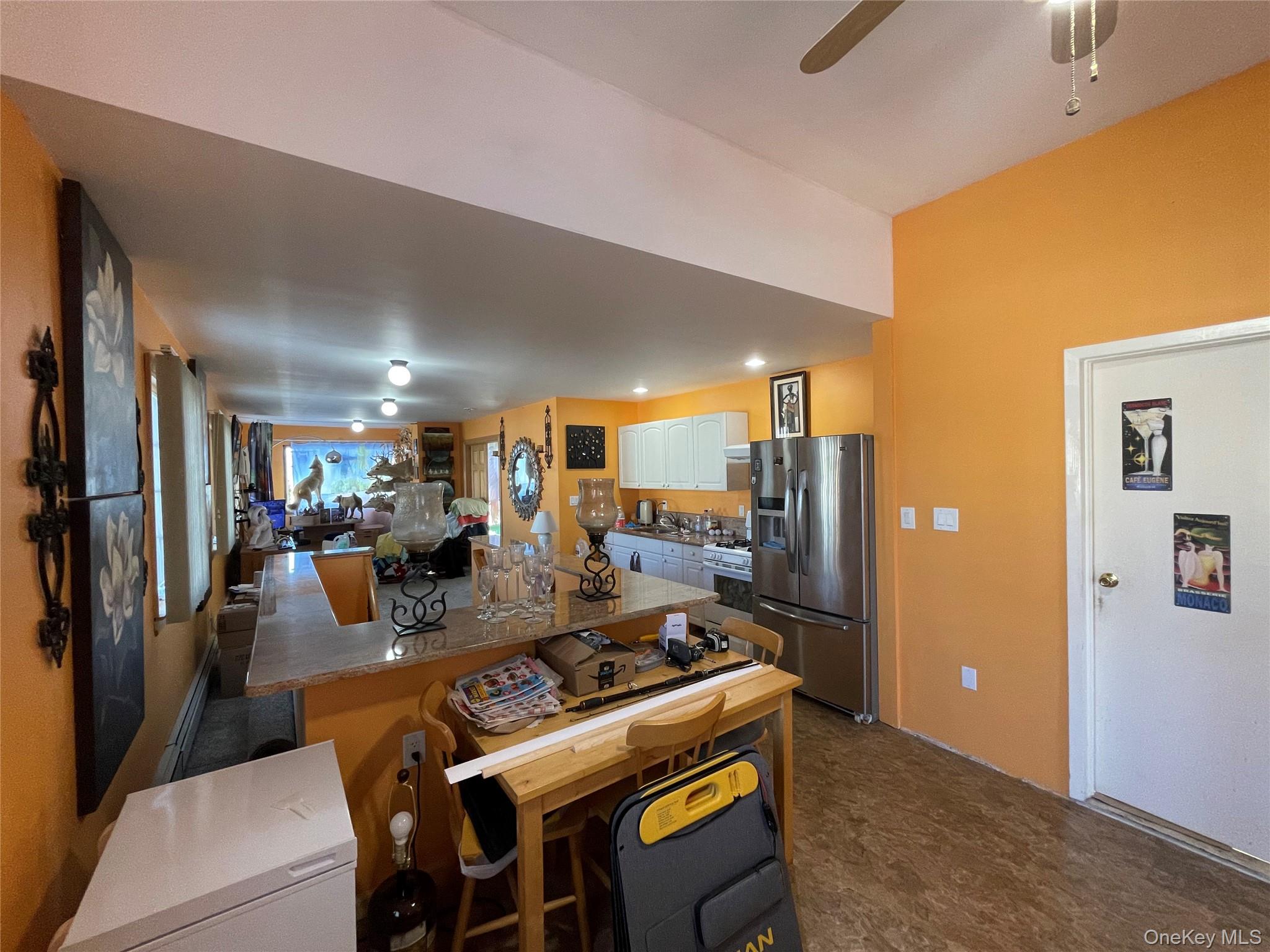 104 Ostend Road Island Park, NY 11558 - Photo 29 of 42 a view of a dining room with furniture a kitchen and chandelier