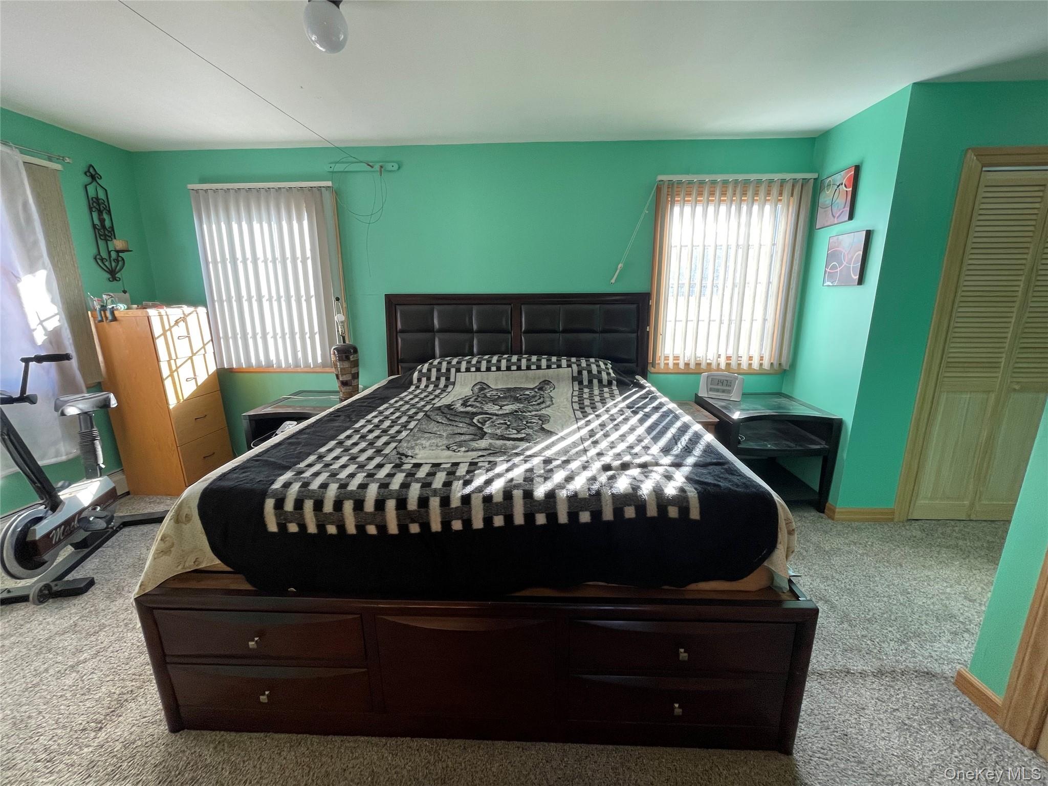 104 Ostend Road Island Park, NY 11558 - Photo 31 of 42 a bed sitting in a bedroom next to a window