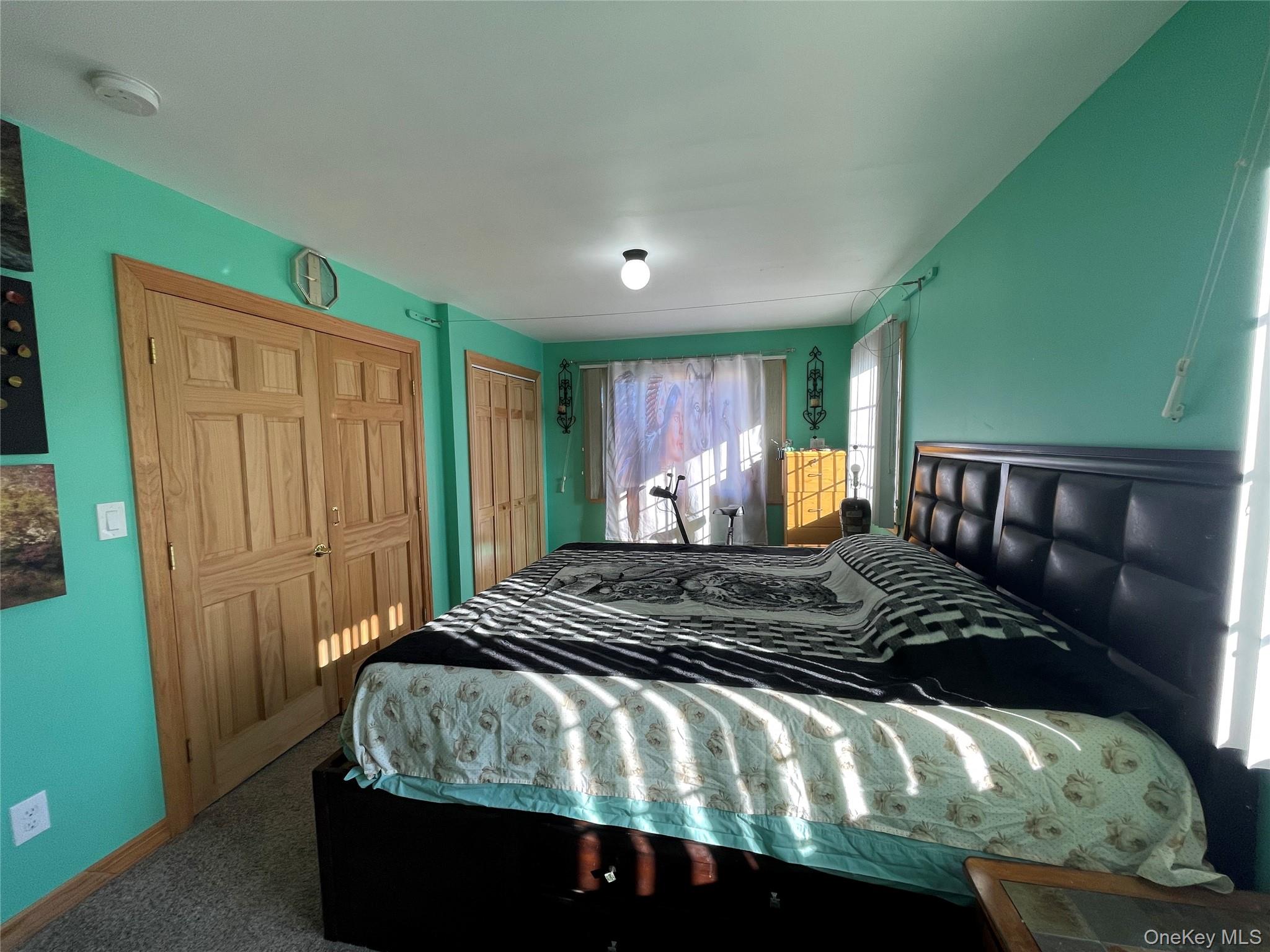 104 Ostend Road Island Park, NY 11558 - Photo 33 of 42 a bedroom with a large bed and a window