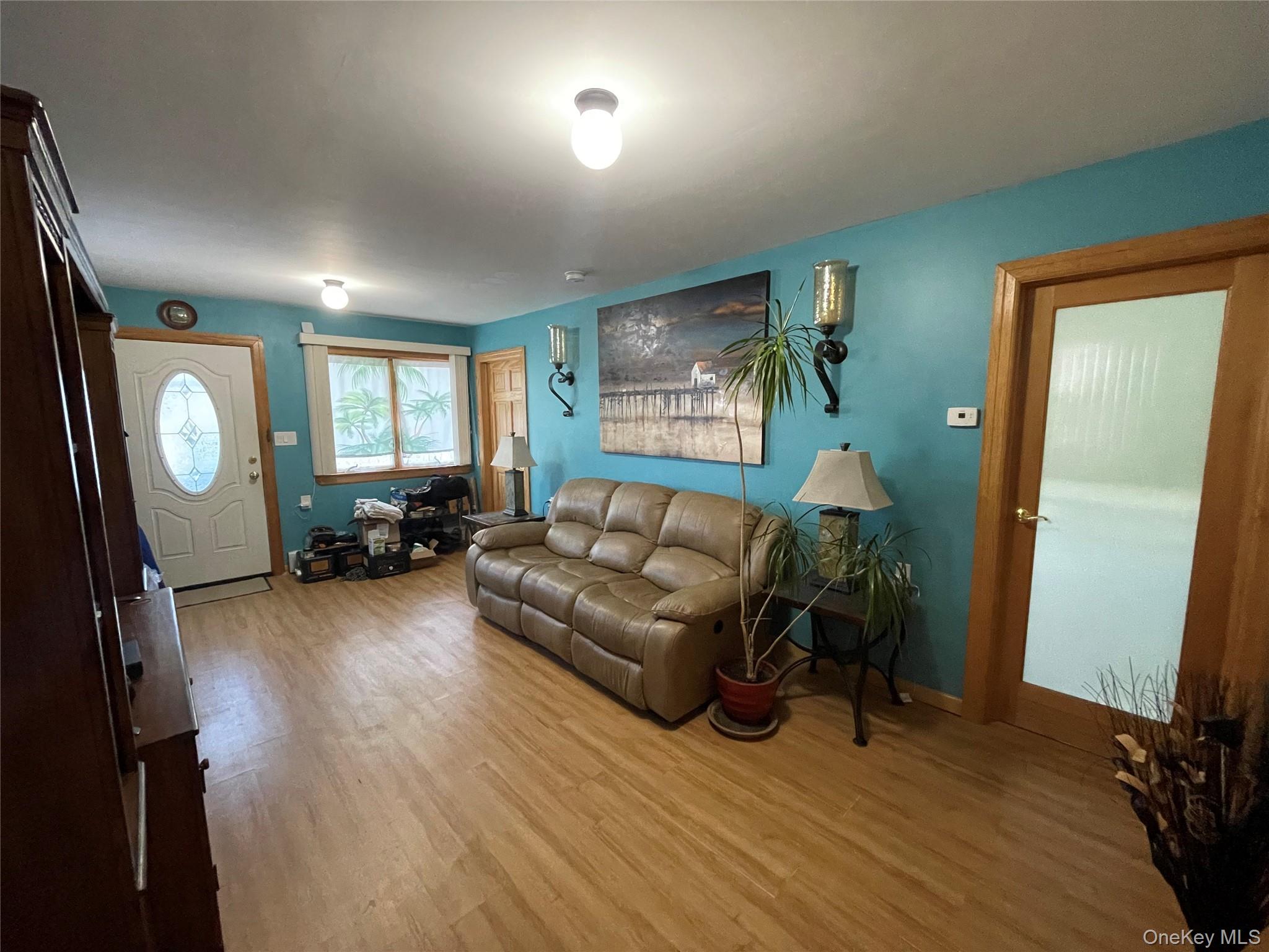 104 Ostend Road Island Park, NY 11558 - Photo 6 of 42 a living room with furniture and a wooden floor
