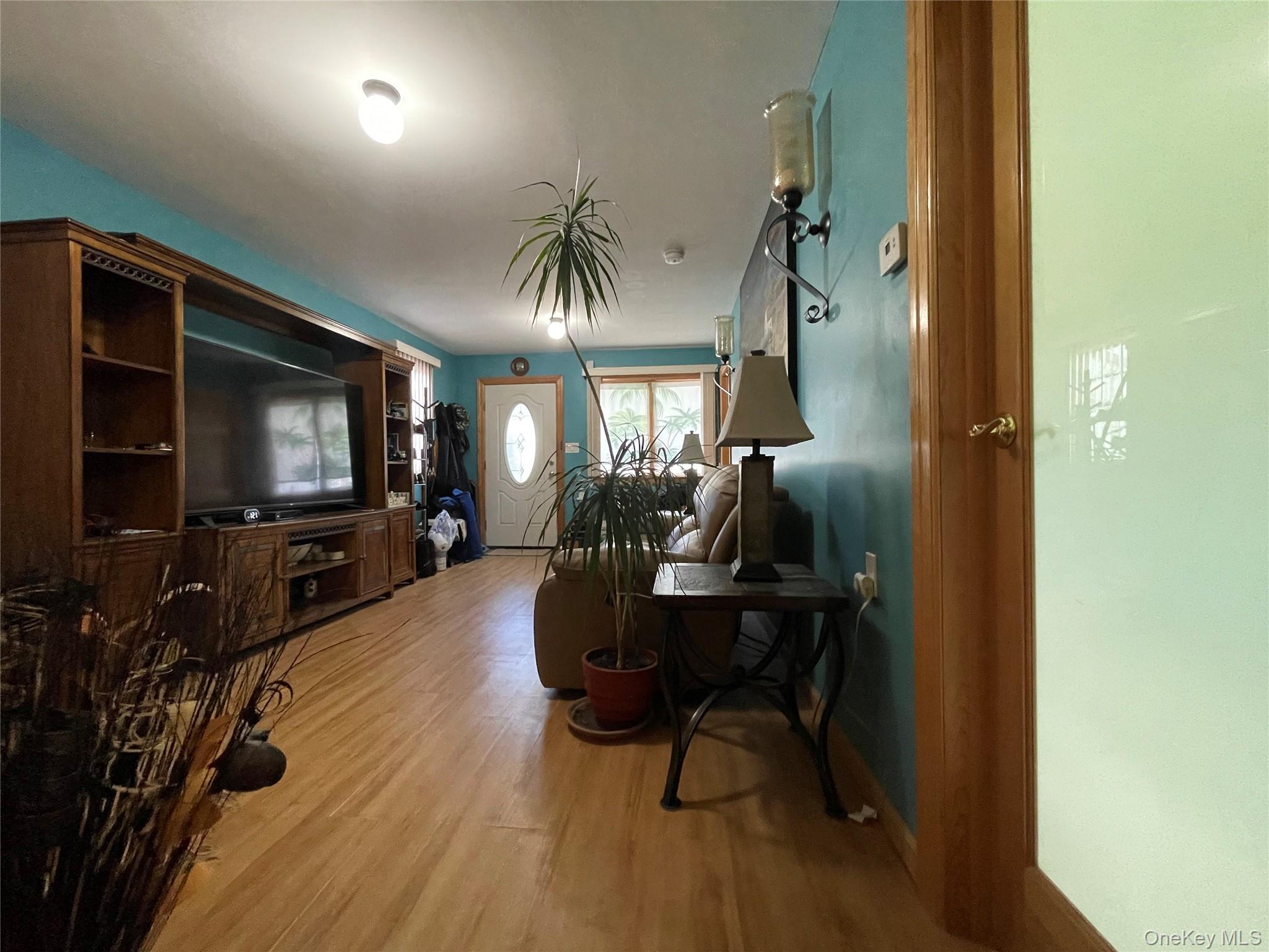 104 Ostend Road Island Park, NY 11558 - Photo 10 of 42 a living room with furniture and a flat screen tv