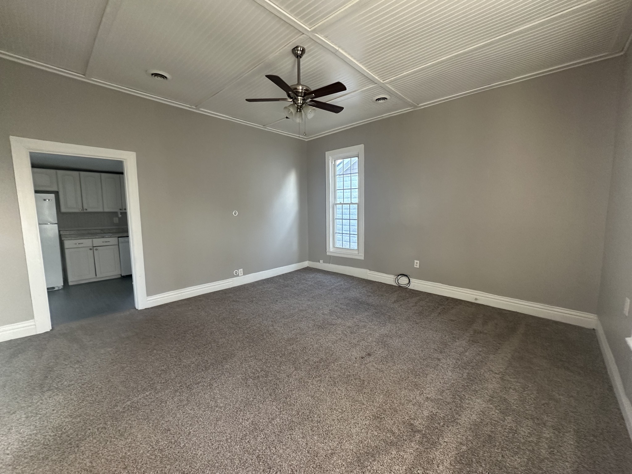 110 Main Street White Bluff, TN 37187 - Photo 3 of 9 an empty room with a ceiling fan and a window