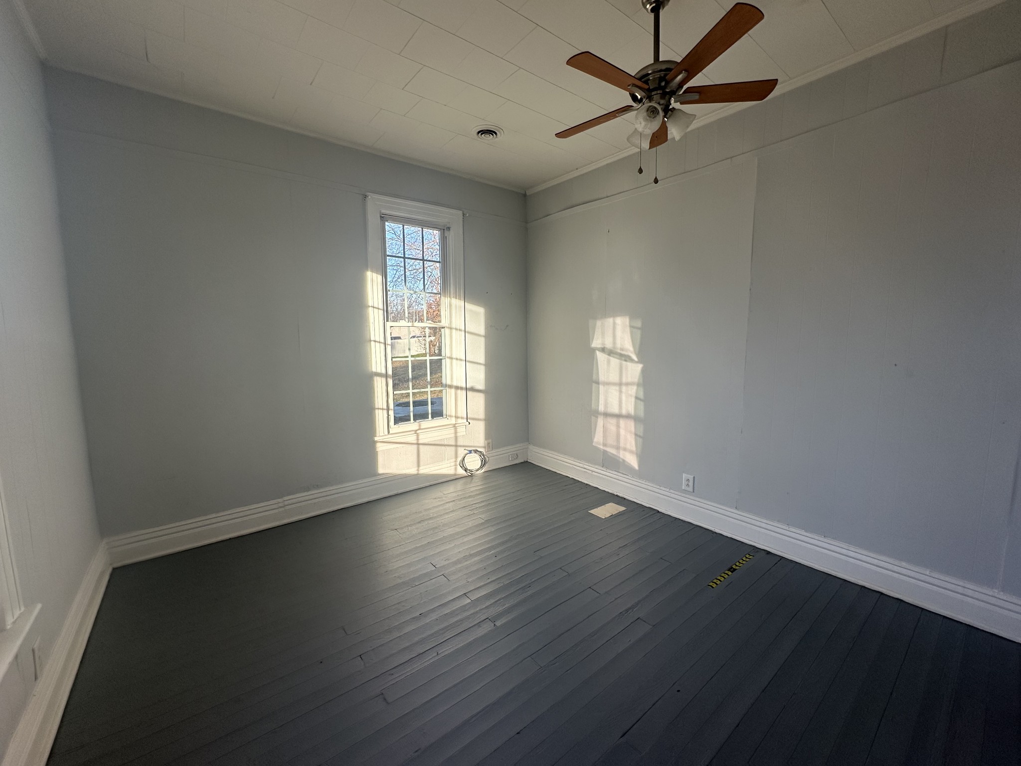 110 Main Street White Bluff, TN 37187 - Photo 6 of 9 an empty room with wooden floor fan and windows