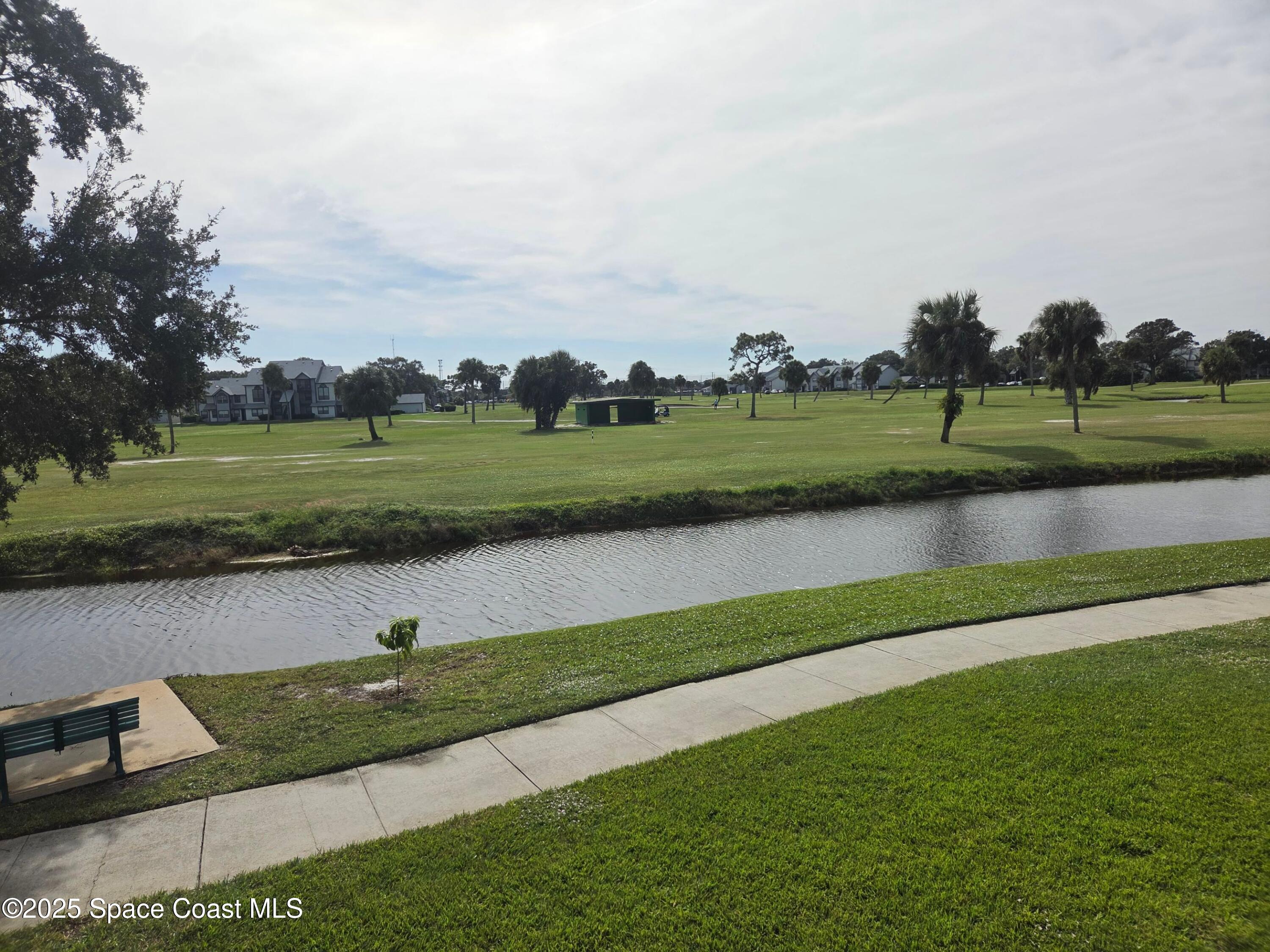 2727 North Wickham Road, Unit 20611 Melbourne, FL 32935 - Photo 9 of 10 an aerial view of a golf course with a lake view