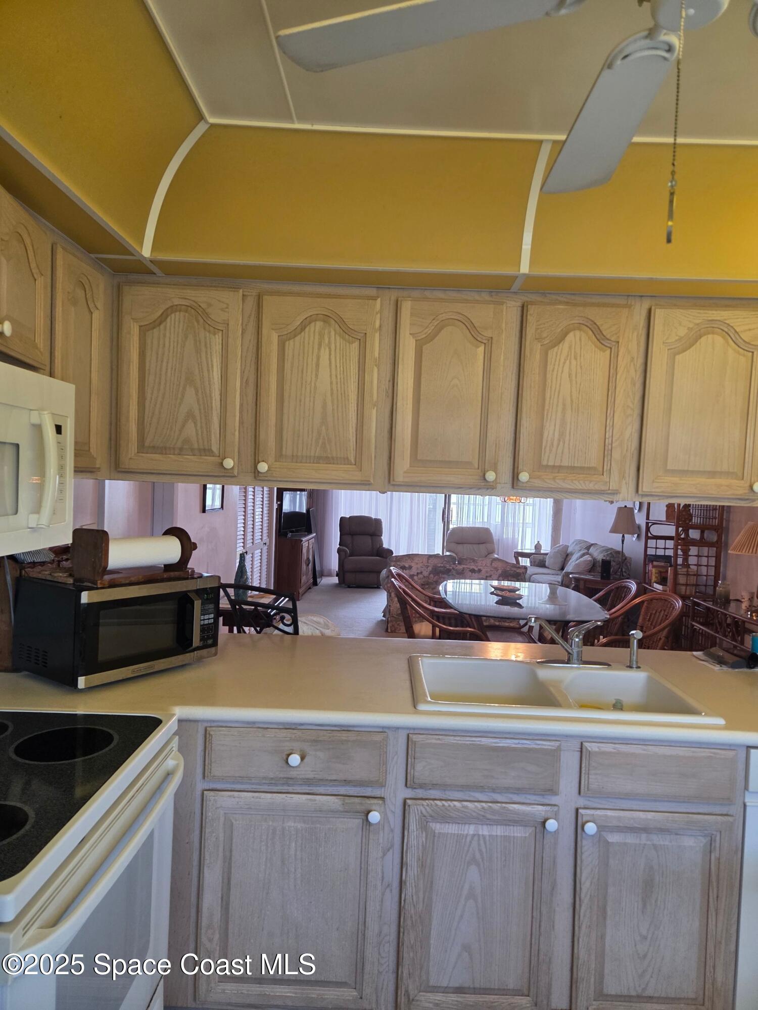 2727 North Wickham Road, Unit 20611 Melbourne, FL 32935 - Photo 10 of 10 a kitchen with a sink and a stove