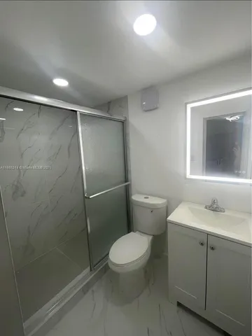 a kitchen with stainless steel appliances a stove a sink and a refrigerator