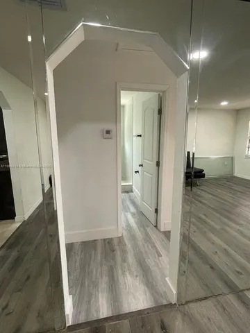 a view of a hallway with wooden floor