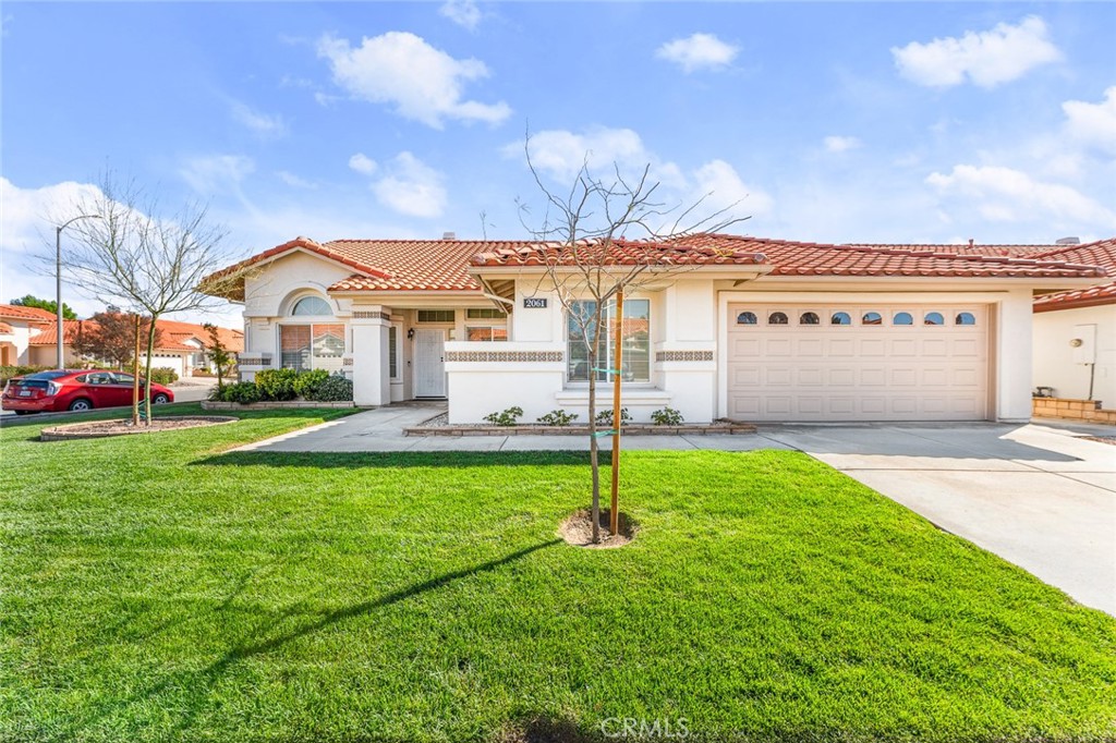 2061 Pecan Tree Street Hemet, CA 92545 - Photo 1 of 23 a front view of a house with garden