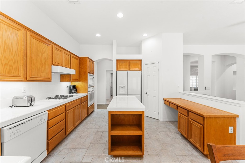 2061 Pecan Tree Street Hemet, CA 92545 - Photo 11 of 23 a large kitchen with stainless steel appliances granite countertop a stove a sink and a refrigerator