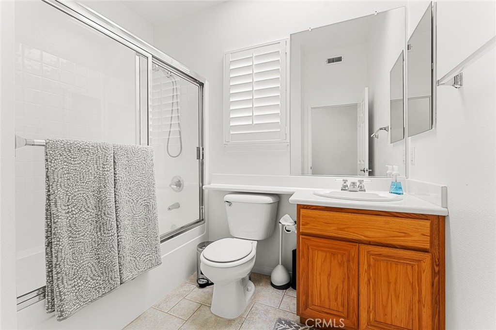 2061 Pecan Tree Street Hemet, CA 92545 - Photo 19 of 23 a bathroom with a granite countertop toilet a sink and a mirror