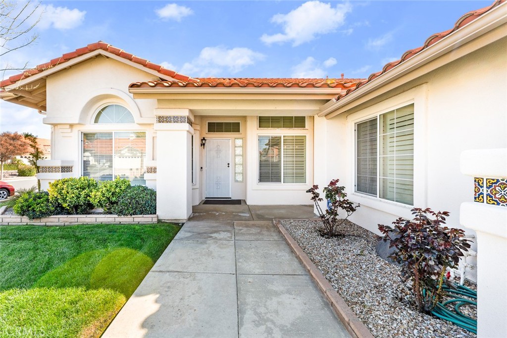 2061 Pecan Tree Street Hemet, CA 92545 - Photo 3 of 23 a view of a white house with a large windows and a lawn chairs
