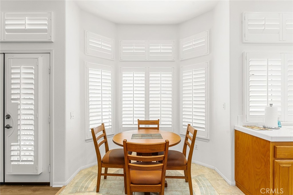 2061 Pecan Tree Street Hemet, CA 92545 - Photo 9 of 23 a view of a dining room with furniture and windows