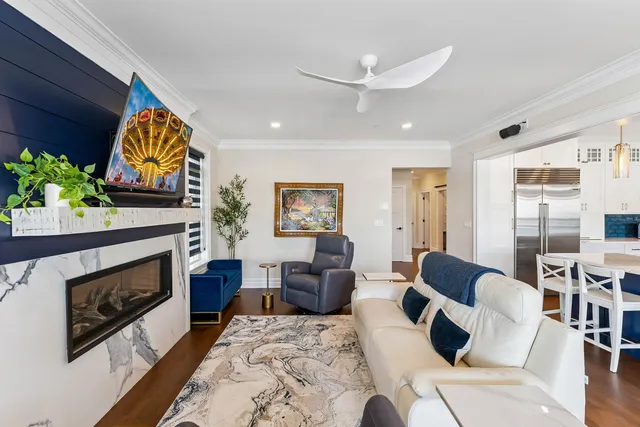 a living room with furniture a fireplace and a flat screen tv