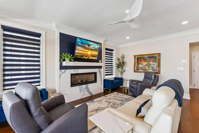 a living room with furniture a fireplace and a flat screen tv