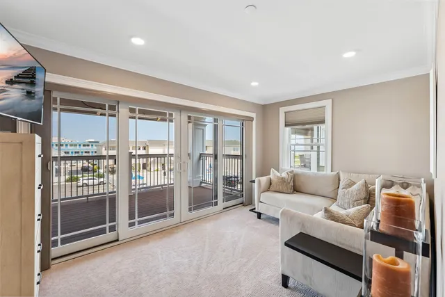 a living room with furniture and a floor to ceiling window