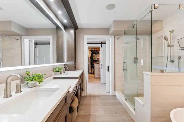 a bathroom with a tub sink and mirror